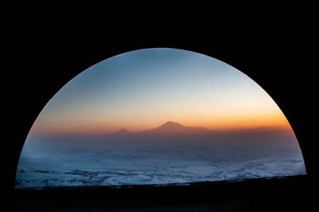 Beautiful view with sunrise and mountain through the tunnelの写真素材