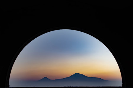 Beautiful view with sunrise and mountain through the tunnelの写真素材