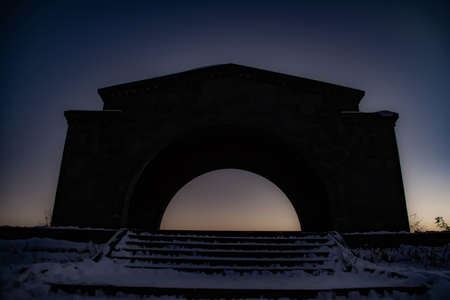 Buildings with an arch on a sunset background. Beautiful architectureの写真素材