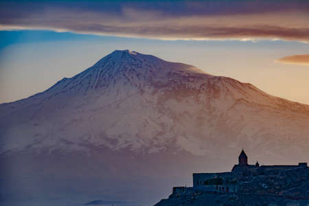Khor Virap Monastery, Mount Ararat and amazing sunset. The silhouette of the monastery on the background of the mountainの写真素材