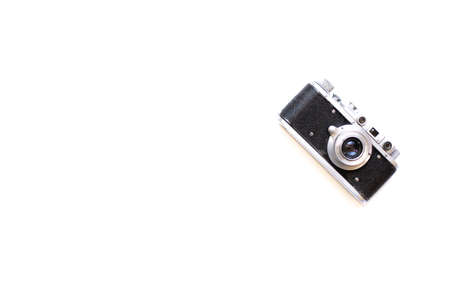 Old camera and on a white background. Metal photo camera and white background for designers and photo studioの写真素材