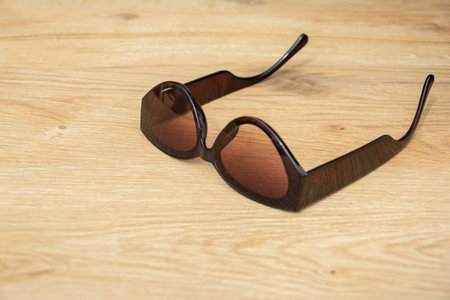 Black sunglasses on the table. wooden table with beautiful textureの写真素材