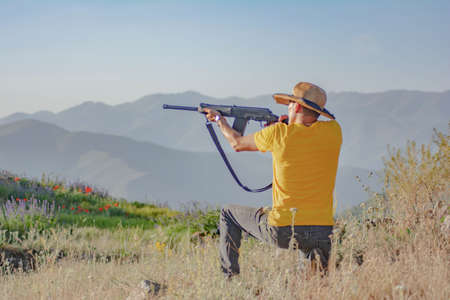 Hunter with a gun. Man holding a gun in his hands