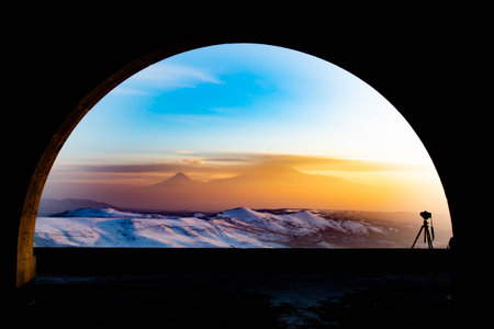 Arch and beautiful sunset. Mount Ararat and golden sunset can be seen through the archの写真素材