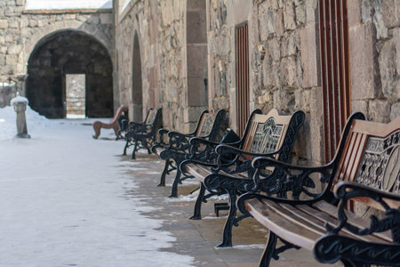Benches in the courtyard of the fortress. Walls of the old fortress and archの写真素材