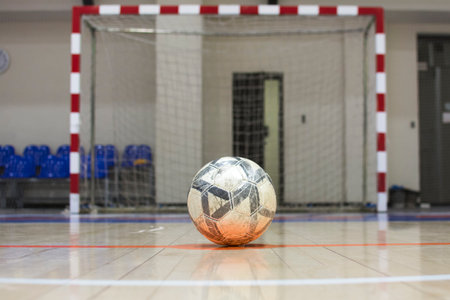 Soccer ball on the floor of a sports hall, indoor shot. soccer ball and gate. mini footballの写真素材