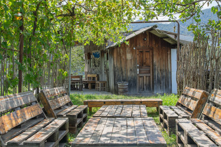 Wooden hut and chairs in the garden at the countryside of Thailandの写真素材