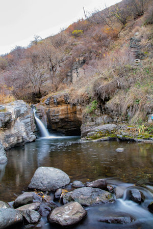 Waterfall in the autumn season. Mountain river in the fall.の写真素材