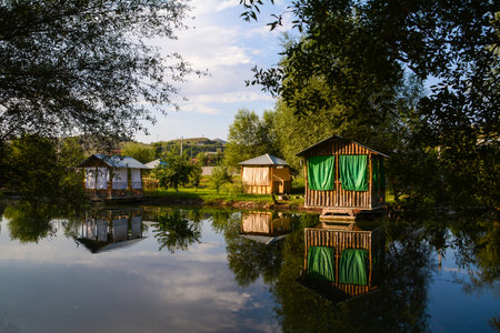 Beautiful summer landscape with wooden houses on the bank of the riverの写真素材
