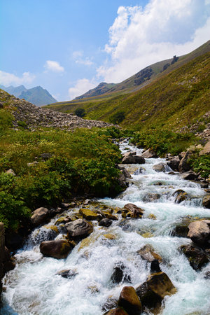mountain stream in the mountains under the blue sky, Caucasus, Russia