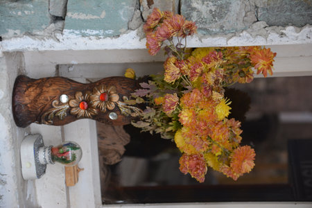 Bouquet of autumn flowers on the windowsill of a shopの写真素材