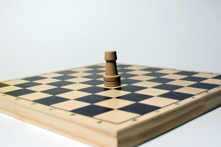 Wooden chessboard with pieces of chess on the white background.の写真素材
