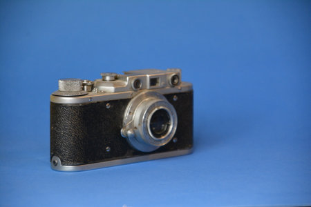 Vintage camera on a blue background. Photo for your design.の写真素材