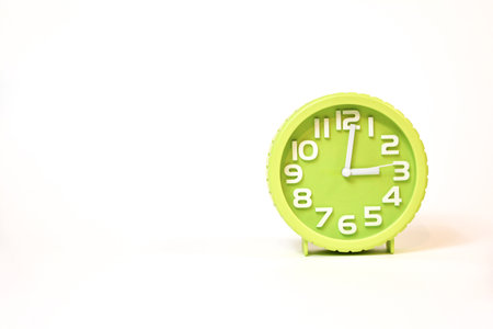 Green alarm clock isolated on white background with copy space for your textの写真素材