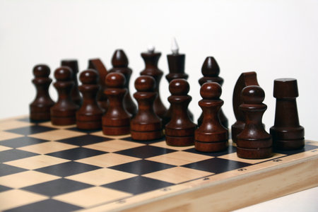Chess pieces on a chessboard, isolated on a white backgroundの写真素材