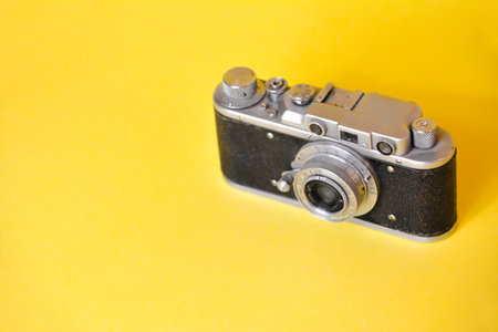 Vintage film camera on yellow background. Copy space for text.の写真素材