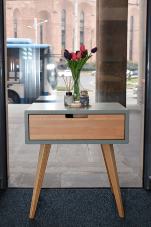 Bouquet of tulips in a vase on a wooden tableの写真素材