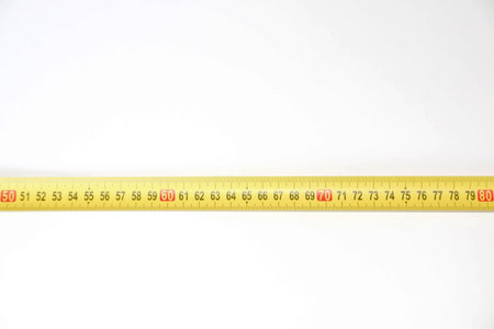Tape measure isolated on white background, closeup of photo.