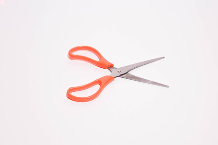 Red scissors isolated on white background. Shallow depth of field.の写真素材