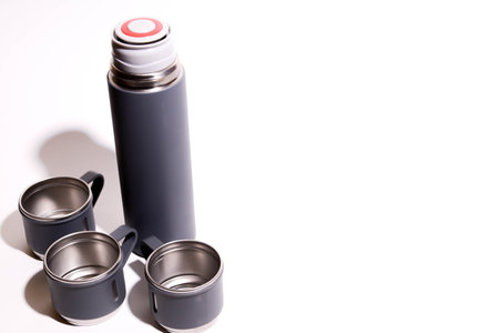 A close up shot of a stainless steel flask on a white backgroundの写真素材