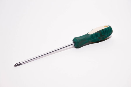 Green screwdriver isolated on white background. Close-up shot.の写真素材
