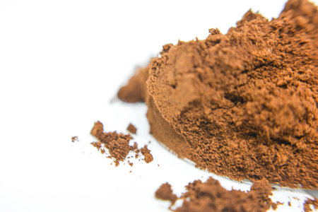 Cocoa powder isolated on white background. Macro shot. Selective focus.の写真素材