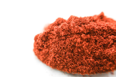 Close-up of a pile of red powder on a white backgroundの写真素材