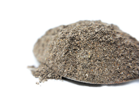 Pile of black pepper powder isolated on white background. Macro.の写真素材