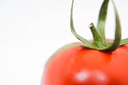 Tomato isolated on a white background. Shallow depth of field.の写真素材