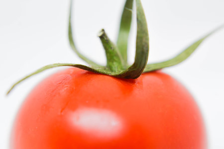 Close up of fresh tomato on white background. Shallow DOF.の写真素材