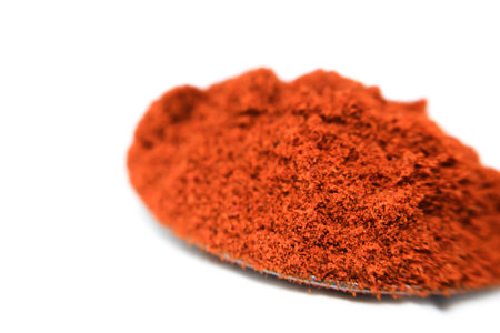 Red paprika powder isolated on white background. Spices and food ingredients.の写真素材