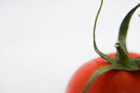 Tomato on a white background. Shallow depth of field.の写真素材