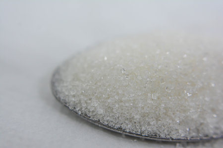 Close up of sugar crystals on a spoon with shallow depth of fieldの写真素材