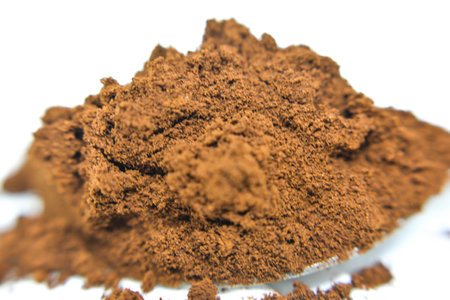 Cocoa powder isolated on white background. Macro shot. Selective focus.の写真素材