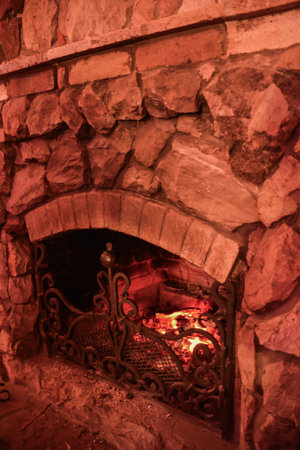 Fireplace in a medieval stone house. Close-up. Selective focus.の写真素材