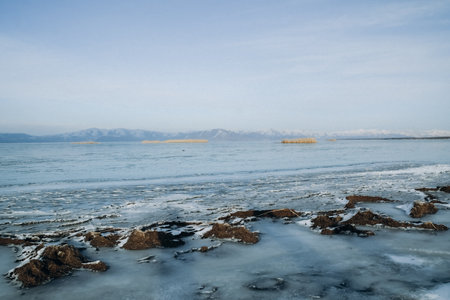 Ice on the frozen lake in winter. Landscape with ice and snow.の写真素材