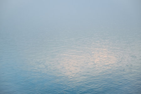 The surface of the water in the fog. Reflection in the water.の写真素材