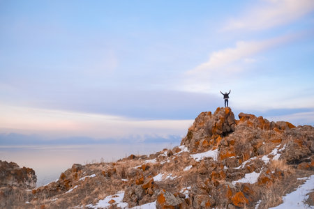 Man standing on top of a mountain and looking to the horizon.の写真素材
