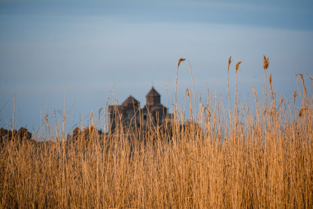 Armenian church in Lake Sevan. Monastery on the river bank. Winter landscape with temple and lakeの写真素材