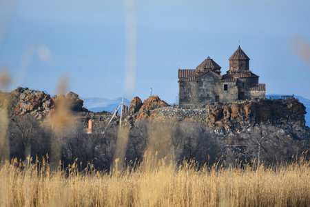 Armenian church in Lake Sevan. Monastery on the river bank. Winter landscape with temple and lakeの写真素材