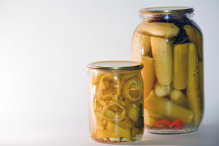 Pickled vegetables in glass jars on a white background. Preserved vegetables.の写真素材
