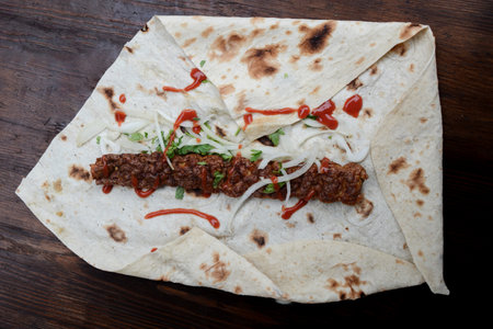 Lula kebab on a pita bread on wooden backgroundの写真素材