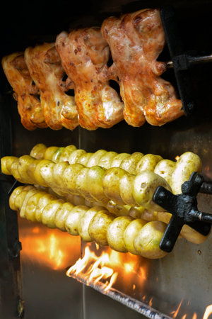 chicken kebab on the spit in the smoke of the barbecueの写真素材