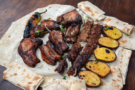 Grilled lamb ribs with grilled potato and herbs on pita breadの写真素材