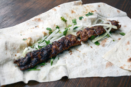Grilled kebab with onion and parsley on pita breadの写真素材