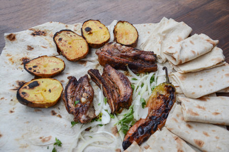 grilled vegetables and meat with pita bread on wooden tableの写真素材