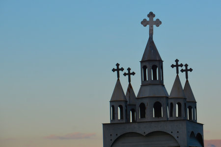 Crosses on the top of the church against the sunset sky.の写真素材