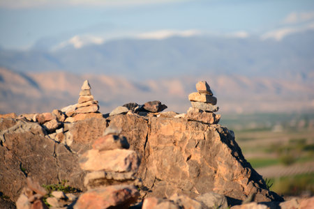 Pyramid of stones on the background of the mountains and the skyの写真素材
