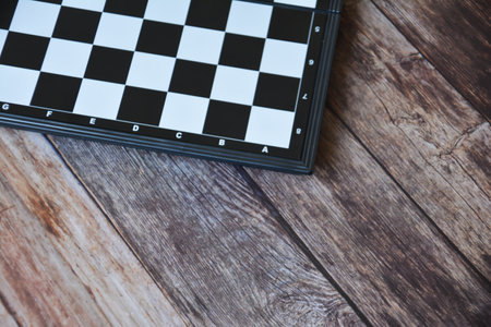 Chess board on wooden table background. Top view with copy space