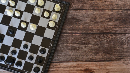 Top view of chess board on wooden table background with copy space.の写真素材